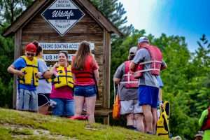 Group of people putting on life jackets in from of Wayne County North Carolina's Paddle Trails
