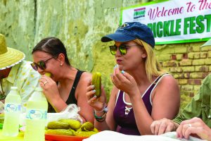 Two women eating pickles at the 2019 Mount Olive Pickle Festival in Goldsboro North Carolina