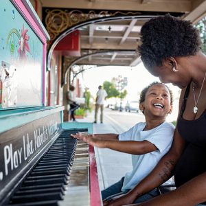 A mother and child playing piano in downtown Goldsboro North Carolina