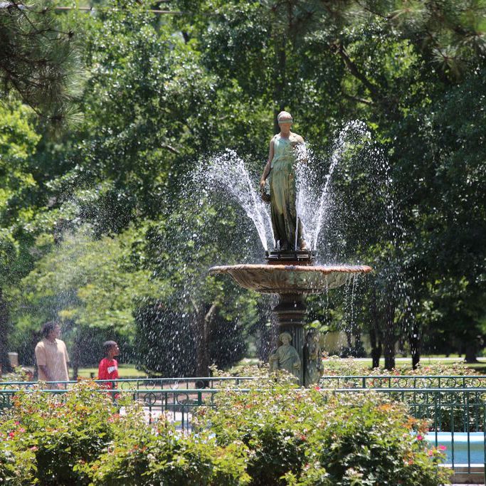 Mother and child gathered around a fountain in a park in Goldsboro North Carolina